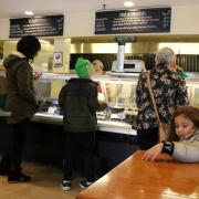 Folks at the deli, ordering lunch.